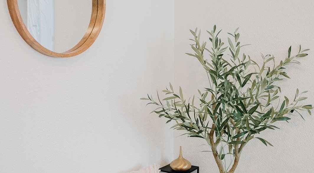 Relaxing corner at The Pamper Room, Bern with a round mirror and lush plant, Bern, Switzerland, CH.