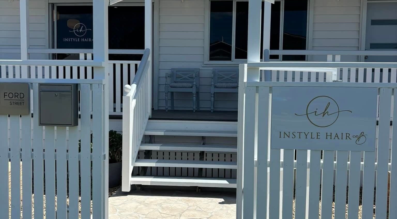 Front porch of KG Massage Therapy, showcasing a serene white fence at Berserker, Queensland, AU.