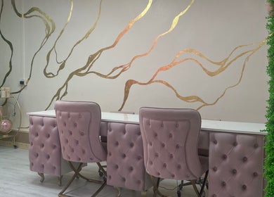Elegant salon chairs at Beautify by Bailey, Willenhall, England, GB, featuring gold wall accents.