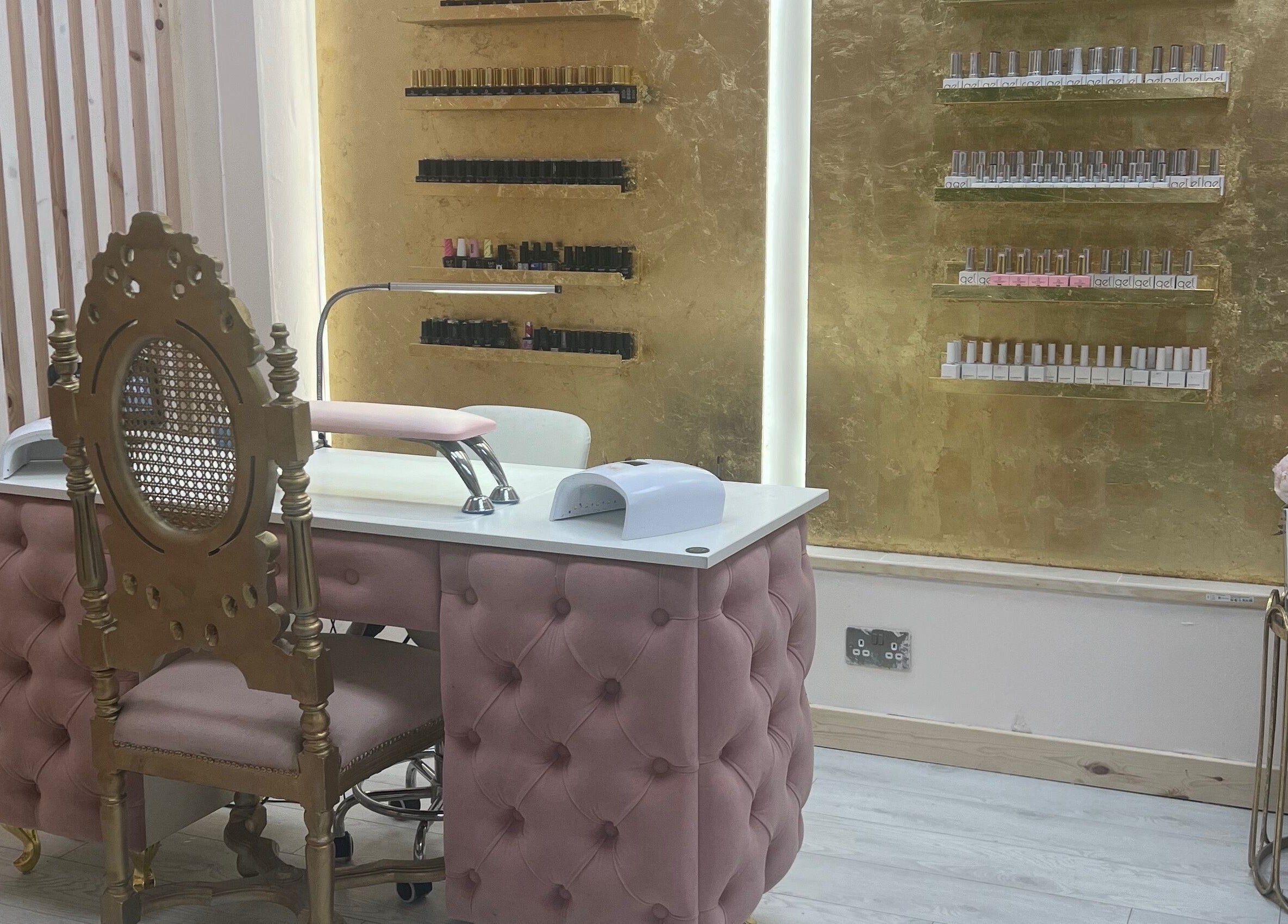 Luxurious nail salon at Beautify by Bailey in Willenhall, England, GB with elegant gold decor and plush pink seating.