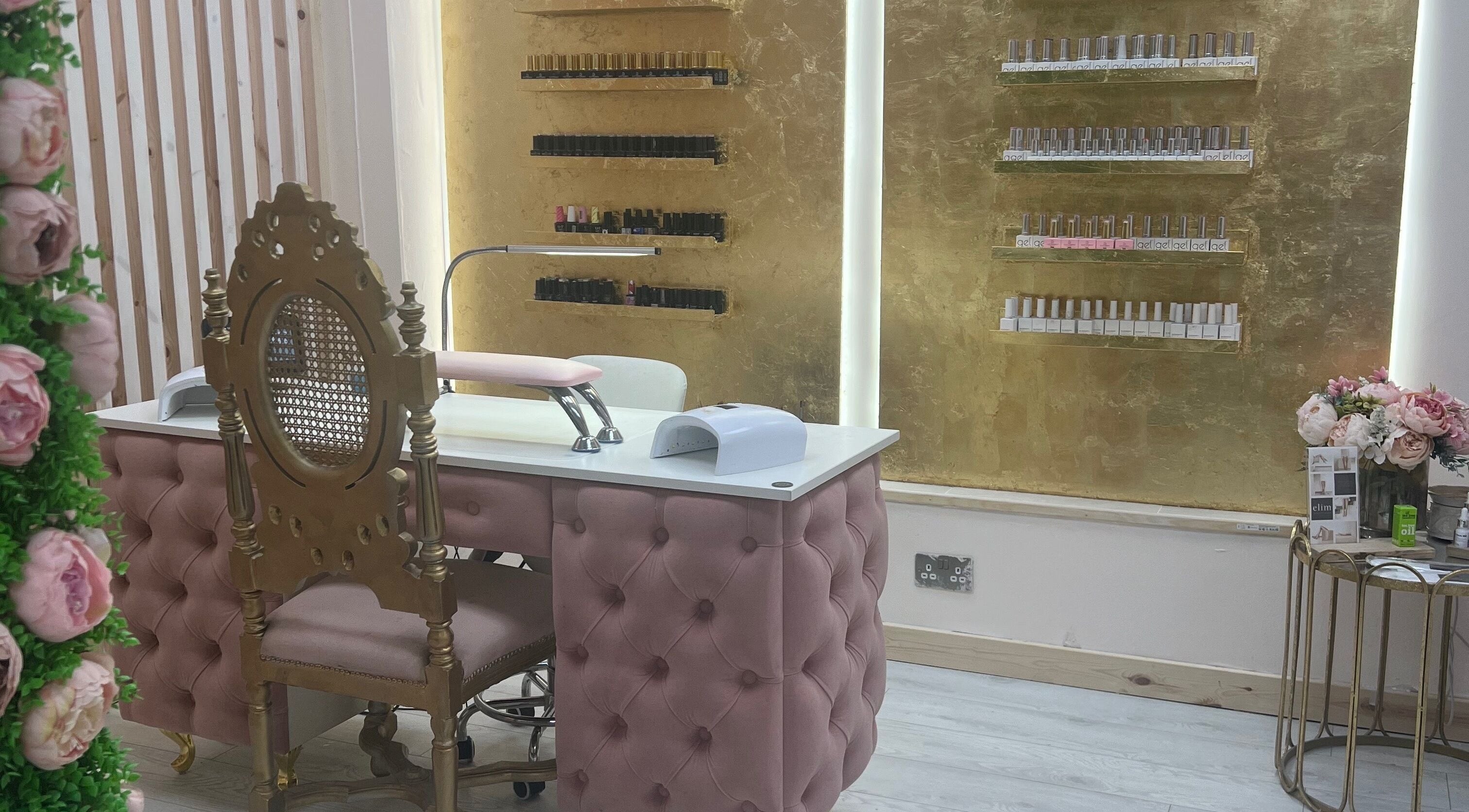 Luxurious nail salon at Beautify by Bailey in Willenhall, England, GB with elegant gold decor and plush pink seating.