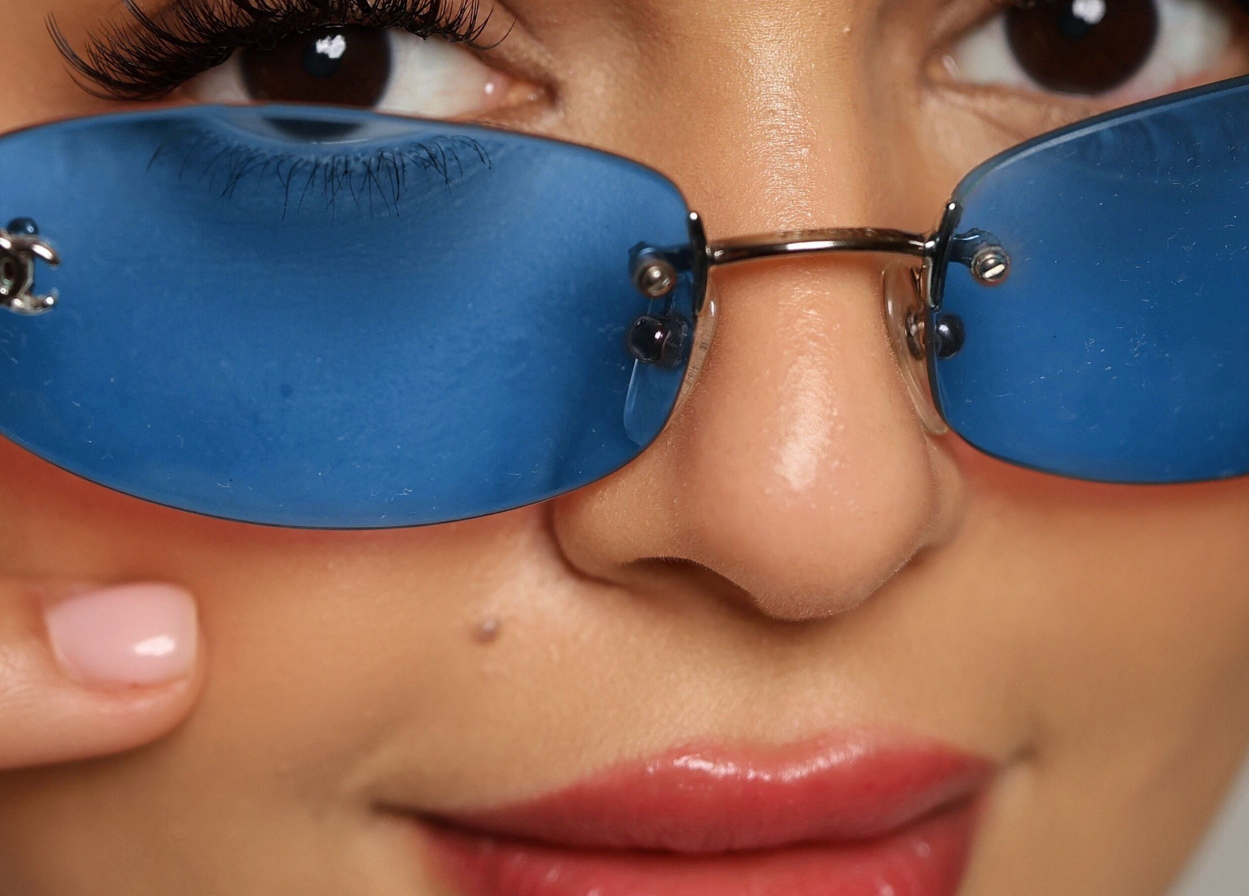 Close-up of a glamorous eye behind blue glasses at Hello Lashes, Riyadh, Riyadh Province, SA.