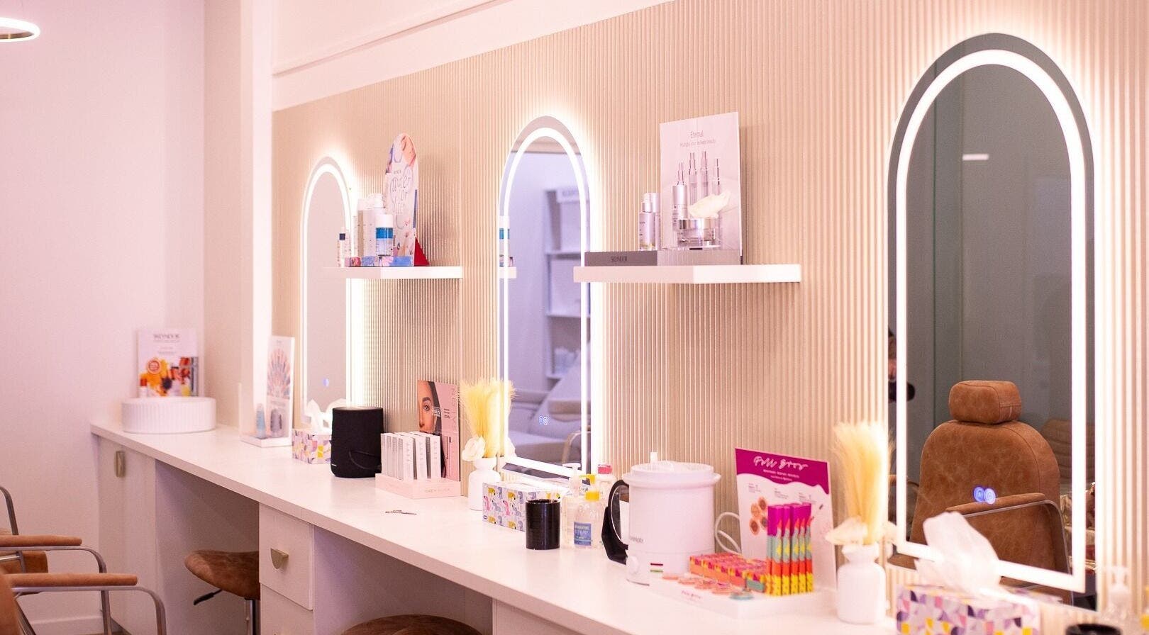 Elegant vanity at WalkIn Pamper Beauty & Brow Bar, Wagga Wagga, New South Wales, AU with chic mirrors and beauty products.