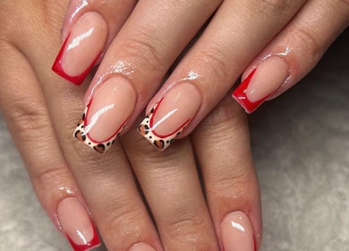 Stylish red-tipped nails with animal print detailing at Glamour, Bawtry, England, GB.