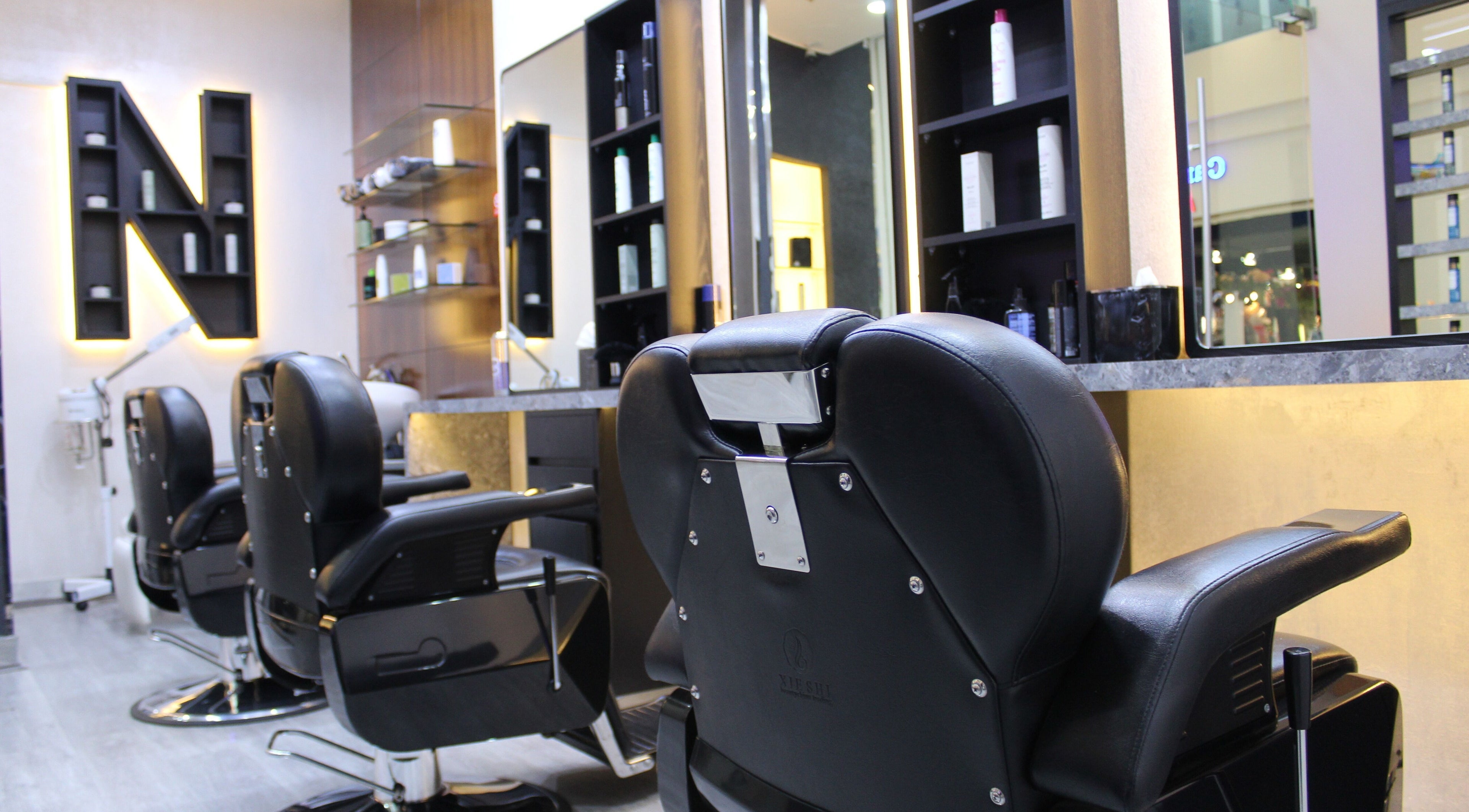 Modern barber chairs at Nomad Gents Salon, Abu Dhabi, AE provide stylish comfort for grooming sessions.