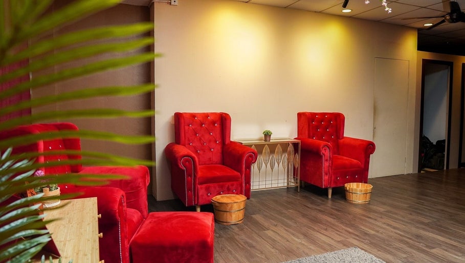 Luxurious red velvet chairs at Qrose Spa, Johor Bahru, Johor, MY, offering a relaxing wellness experience.