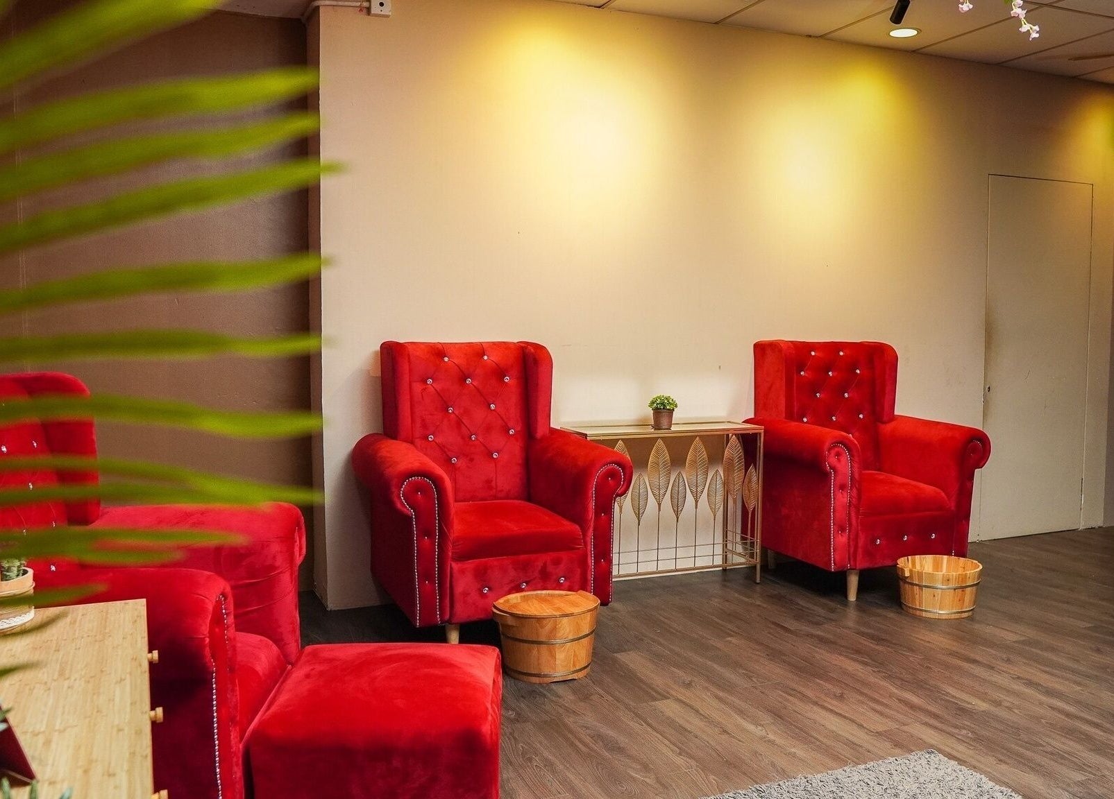 Luxurious red velvet chairs at Qrose Spa, Johor Bahru, Johor, MY, offering a relaxing wellness experience.