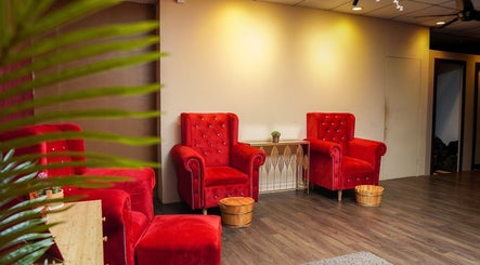 Luxurious red velvet chairs at Qrose Spa, Johor Bahru, Johor, MY, offering a relaxing wellness experience.