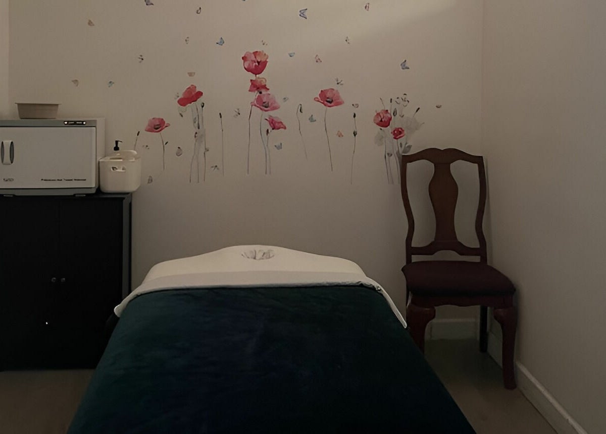 Tranquil massage room at Healing Spa & Massage, West Palm Beach, Florida, US with floral decor and cozy ambiance.