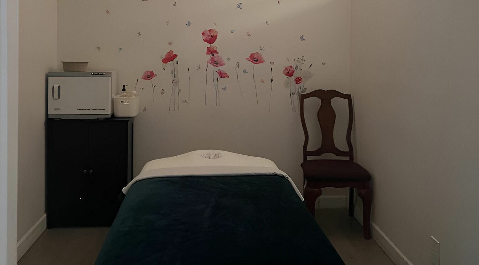 Tranquil massage room at Healing Spa & Massage, West Palm Beach, Florida, US with floral decor and cozy ambiance.