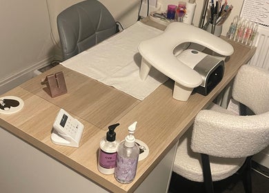 Modern nail station setup at KeeKeesBeauty, Swindon, England, GB showcasing manicure tools and cozy seating.