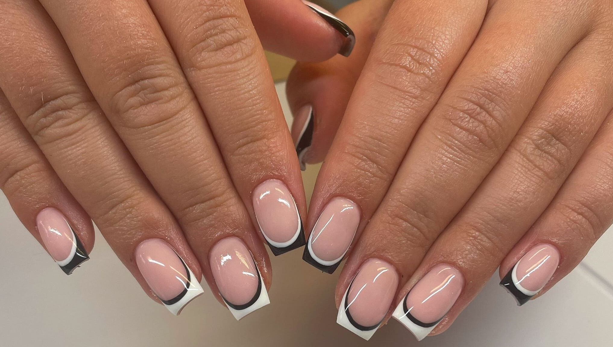 Elegant French manicure with black tips at By Emer in carlow, carlow, IE.