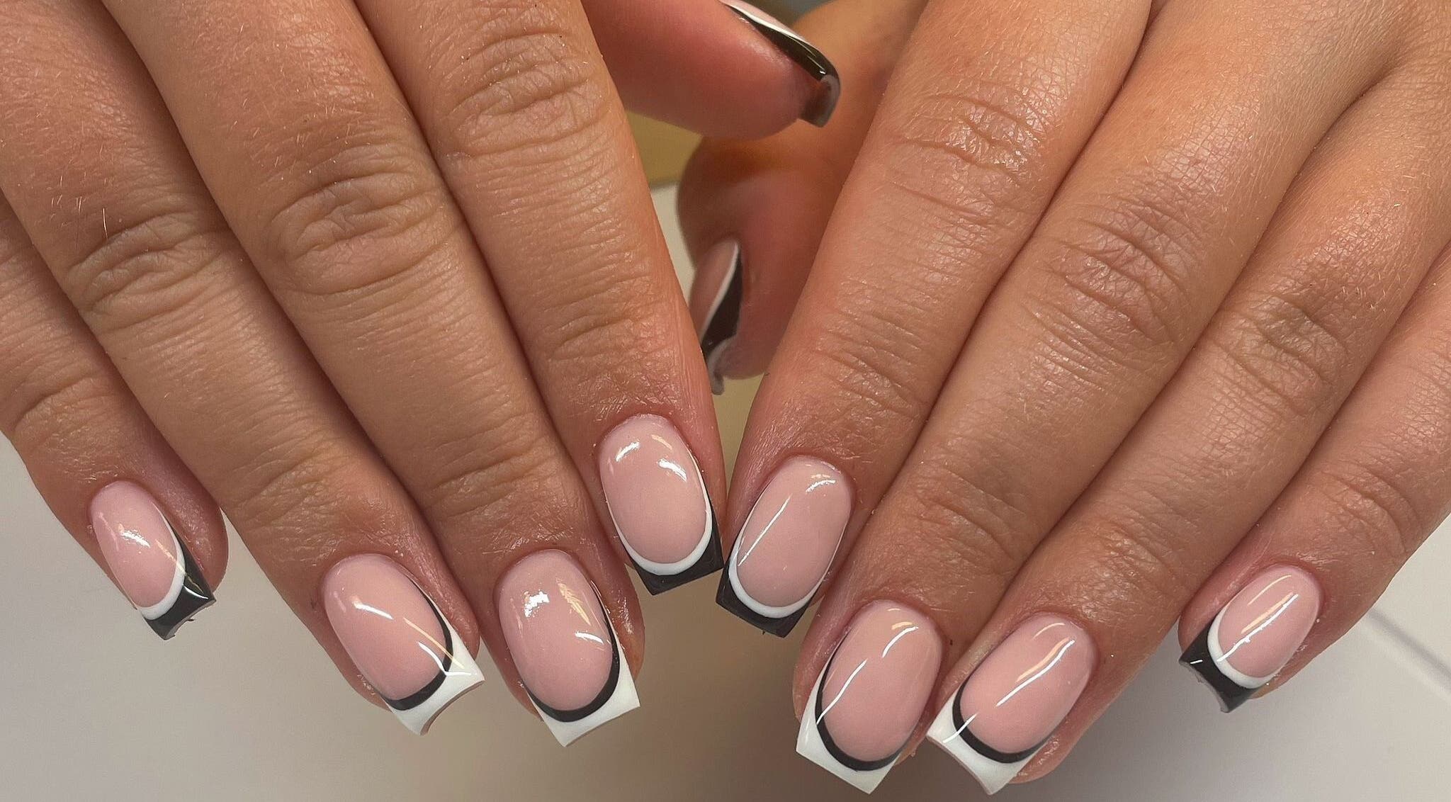 Elegant French manicure with black tips at By Emer in carlow, carlow, IE.