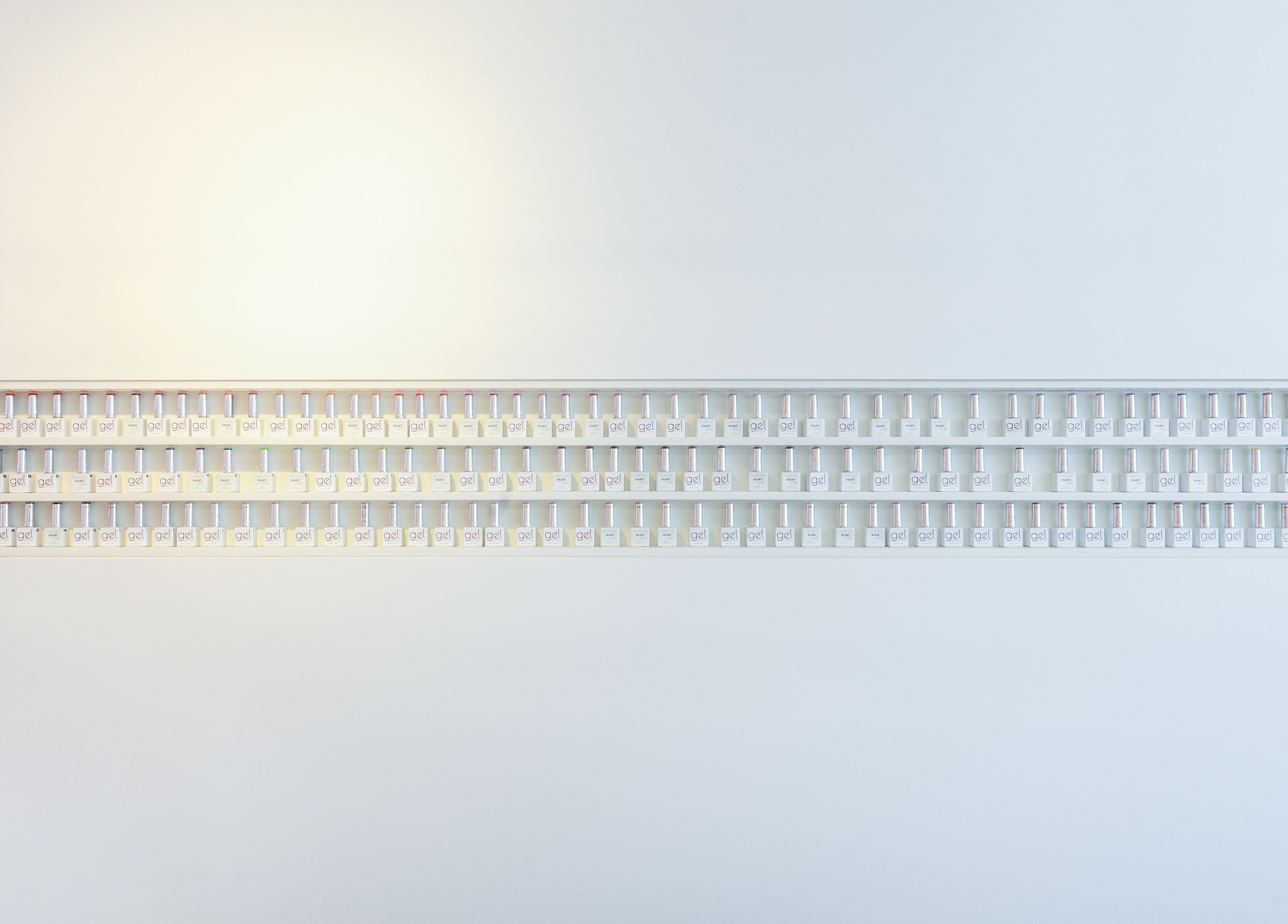 Nail polishes arrayed on a wall at Code Rose - Yarraville, Melbourne, Victoria, AU. Modern beauty vibe.