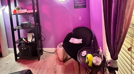 Cozy corner in Lemmey Esthetics, Addison, Texas featuring a plush chair and ambient lighting.