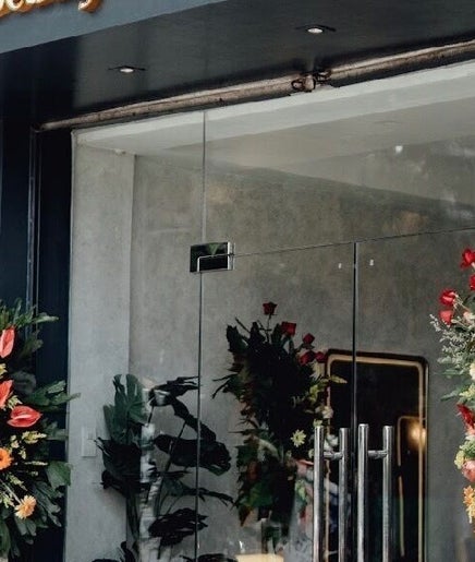Elegant entrance of Glamore Beauty Lounge Jaro Branch, Iloilo City, Western Visayas, PH with floral decor.