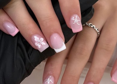 Pink and white nail art at Bella nails and beauty xx in Halstead, England, GB. Intricate floral designs.
