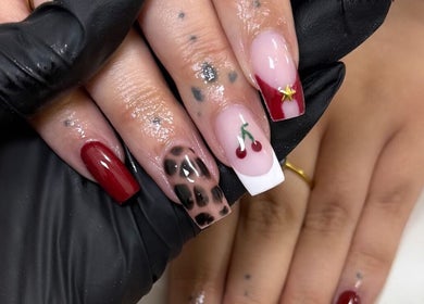 Stylish nail art with cherry and leopard designs at Bella nails and beauty xx, Halstead, England, GB.