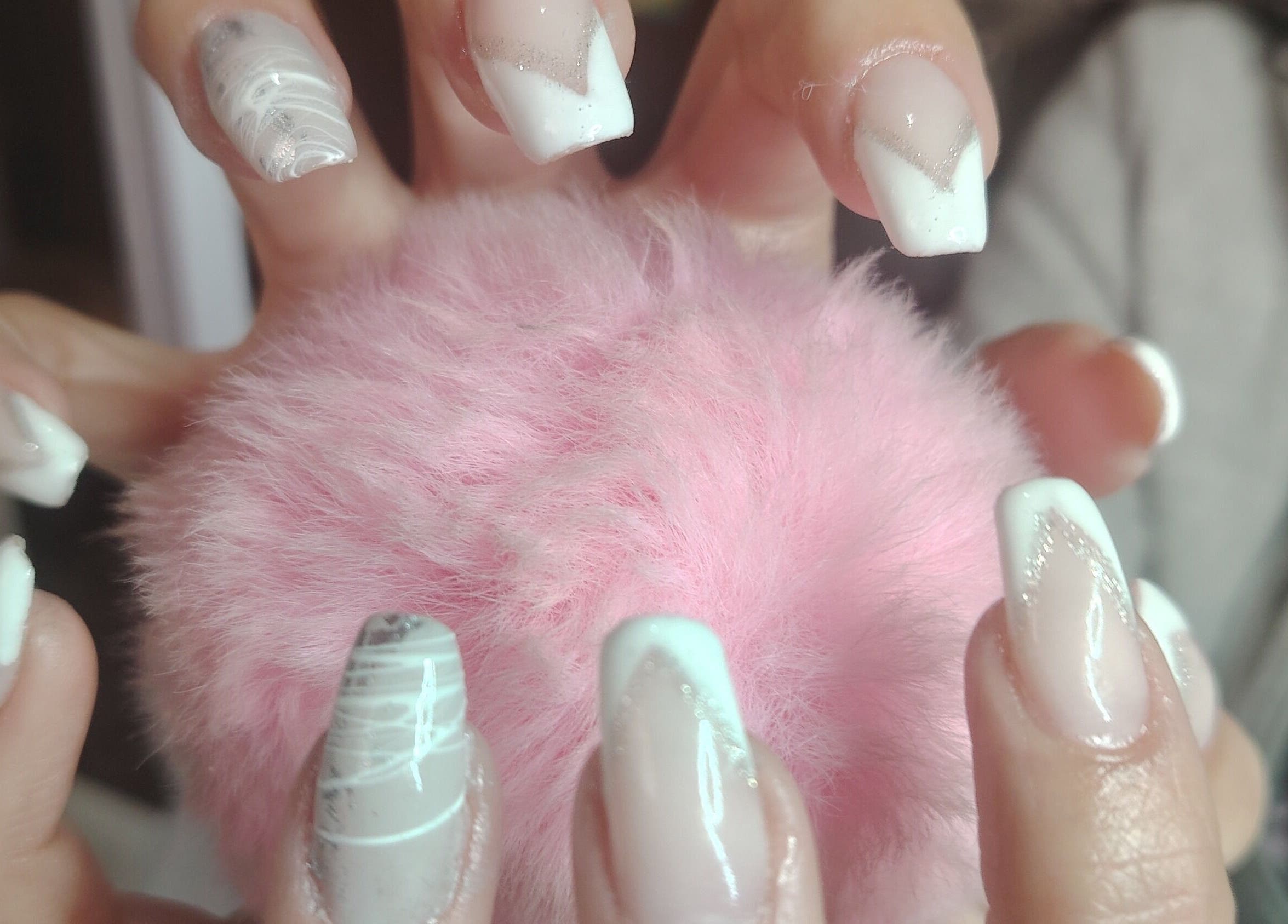 Elegant nail art at Funky Nails, Alberton, Gauteng, ZA. Featuring white and pink designs on a fluffy background.