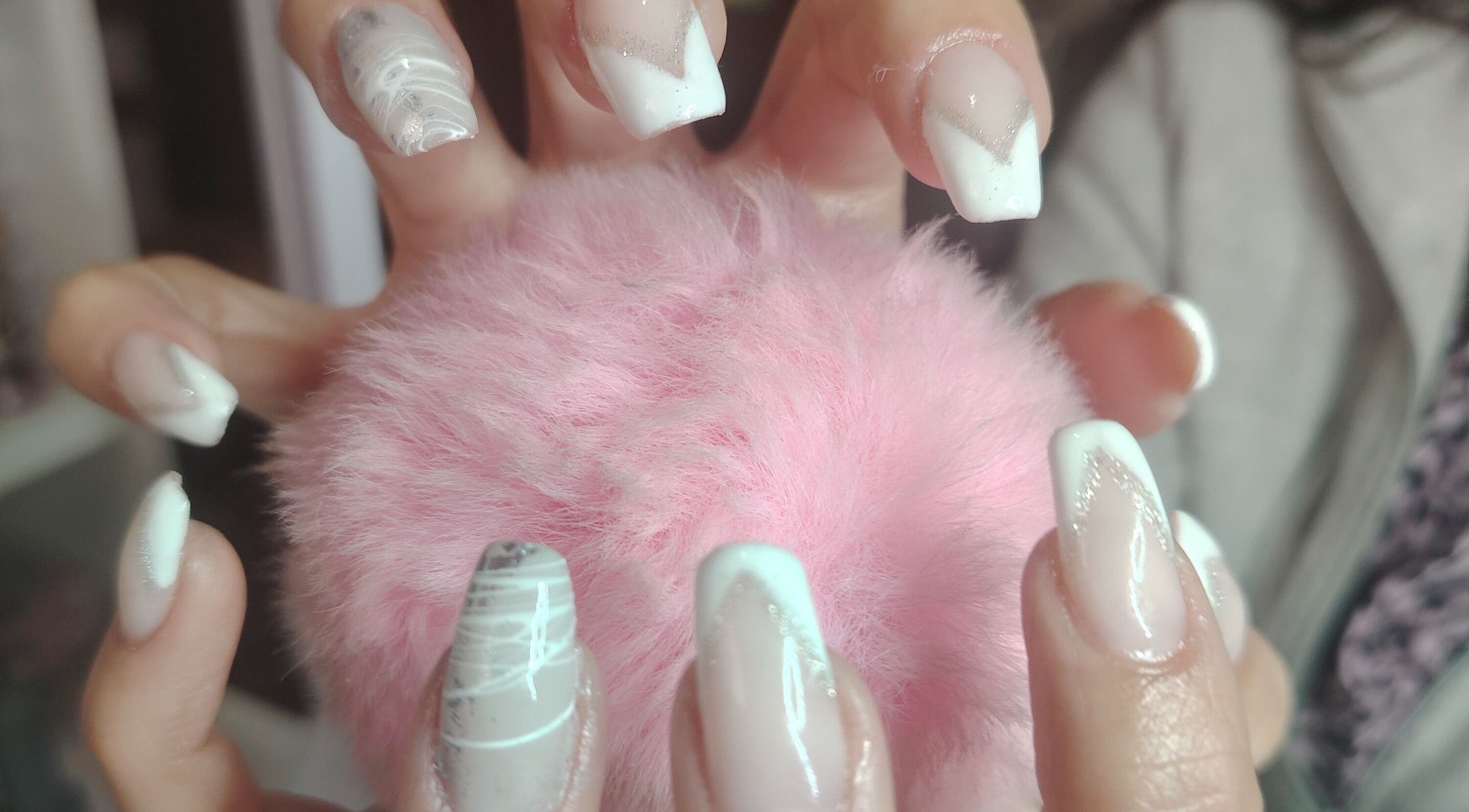Elegant nail art at Funky Nails, Alberton, Gauteng, ZA. Featuring white and pink designs on a fluffy background.