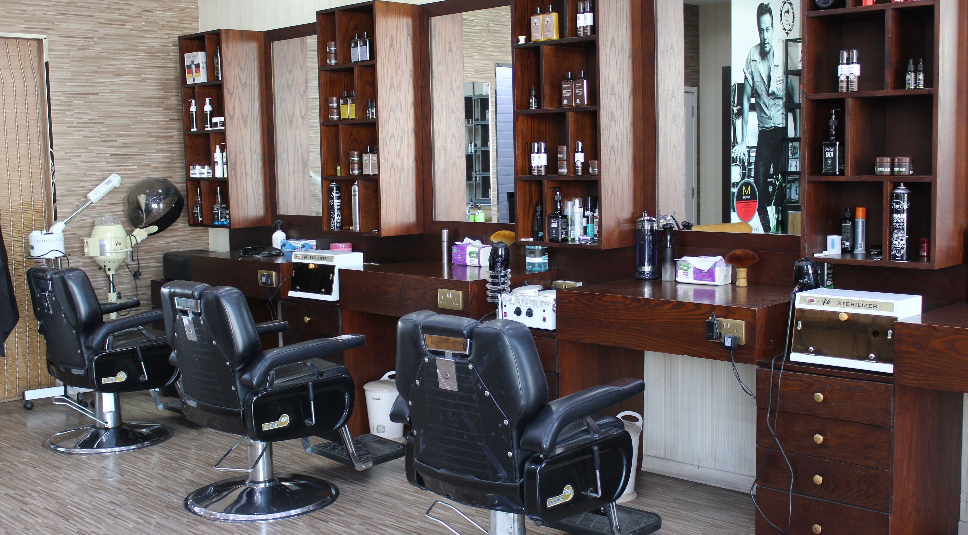 Sleek styling chairs at The One Gents Salon (Impz Branch), Dubai, Dubai, AE offer a luxurious grooming experience.
