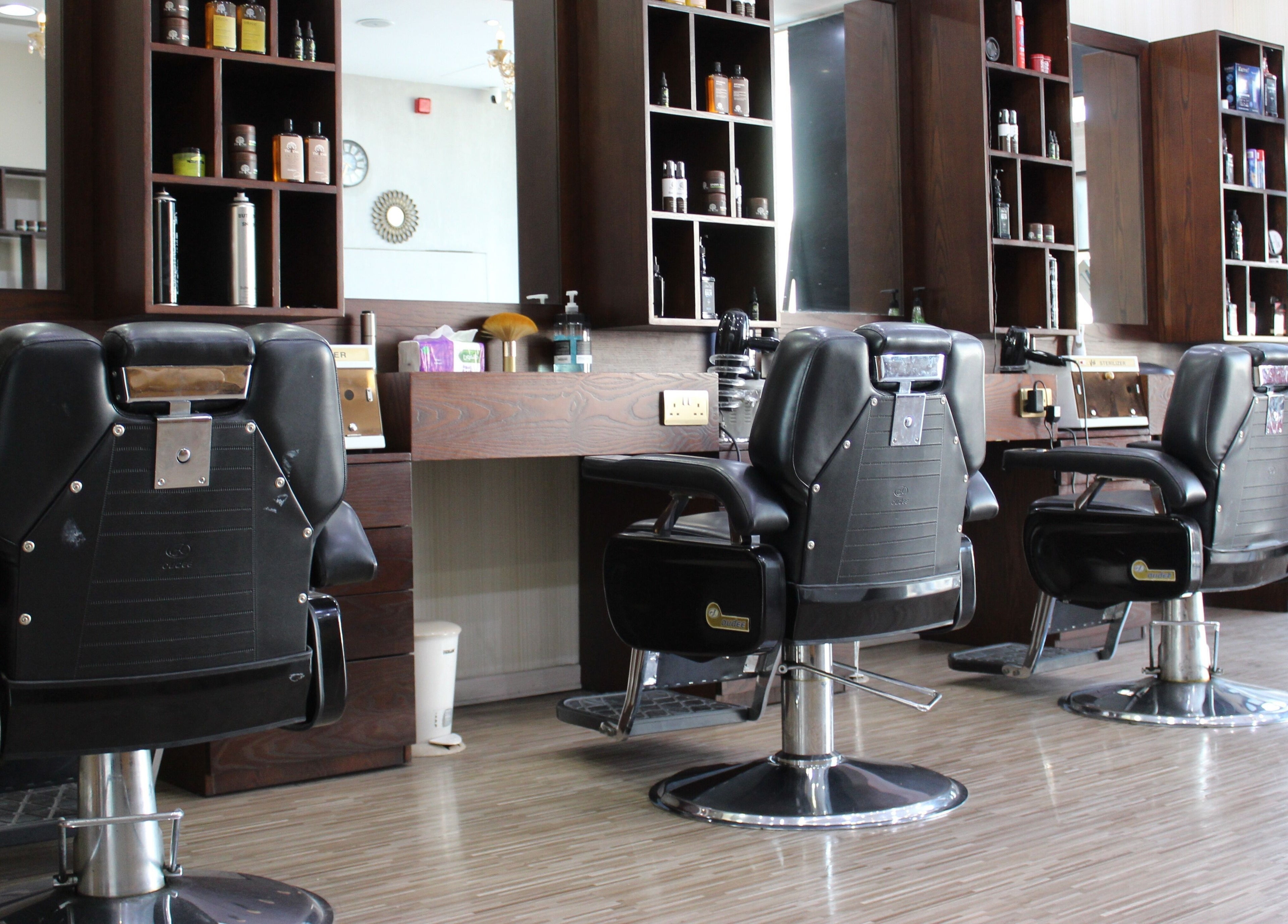 Elegant barber chairs at The One Gents Salon (Impz Branch), Dubai, Dubai, AE showcasing modern style.