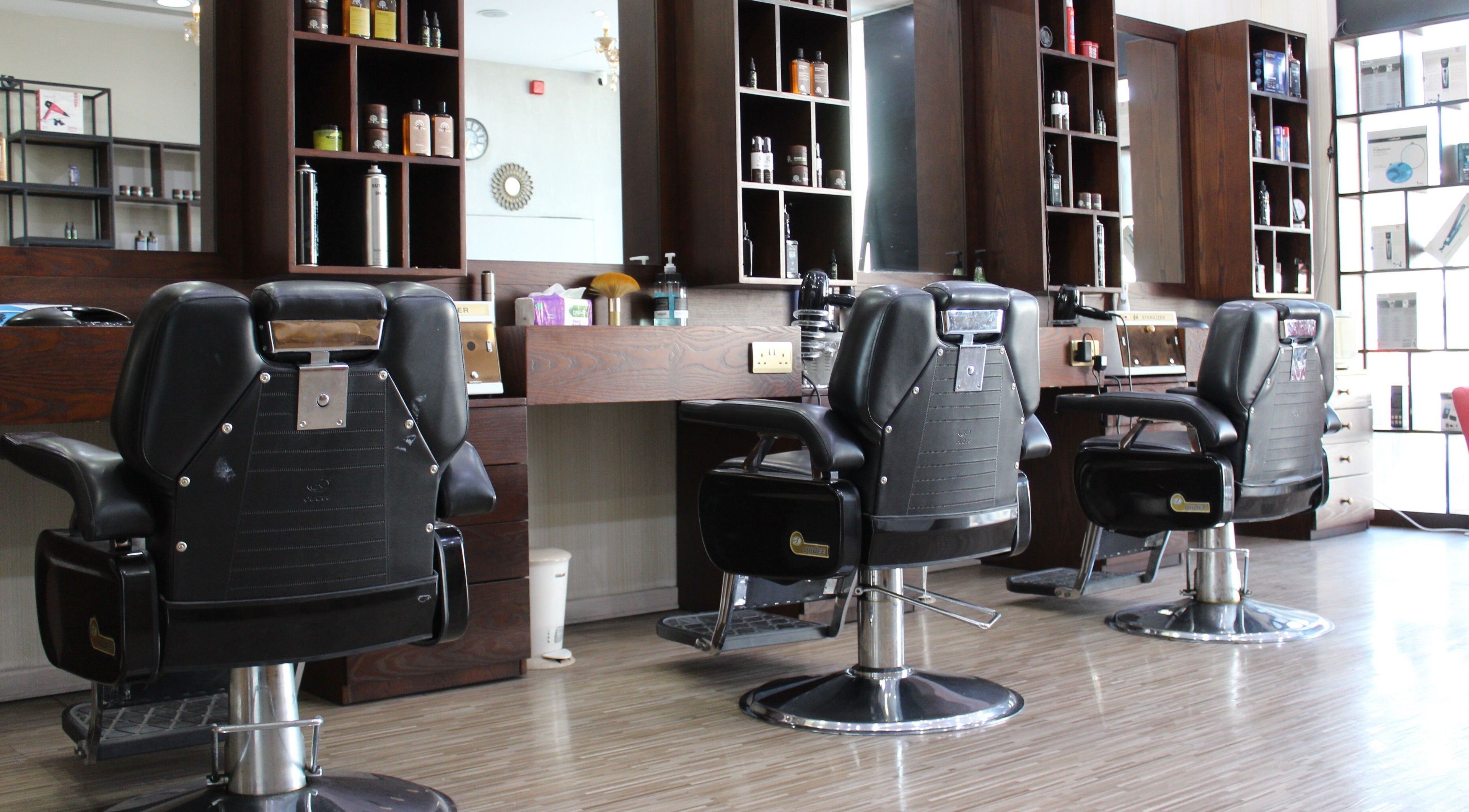 Elegant barber chairs at The One Gents Salon (Impz Branch), Dubai, Dubai, AE showcasing modern style.