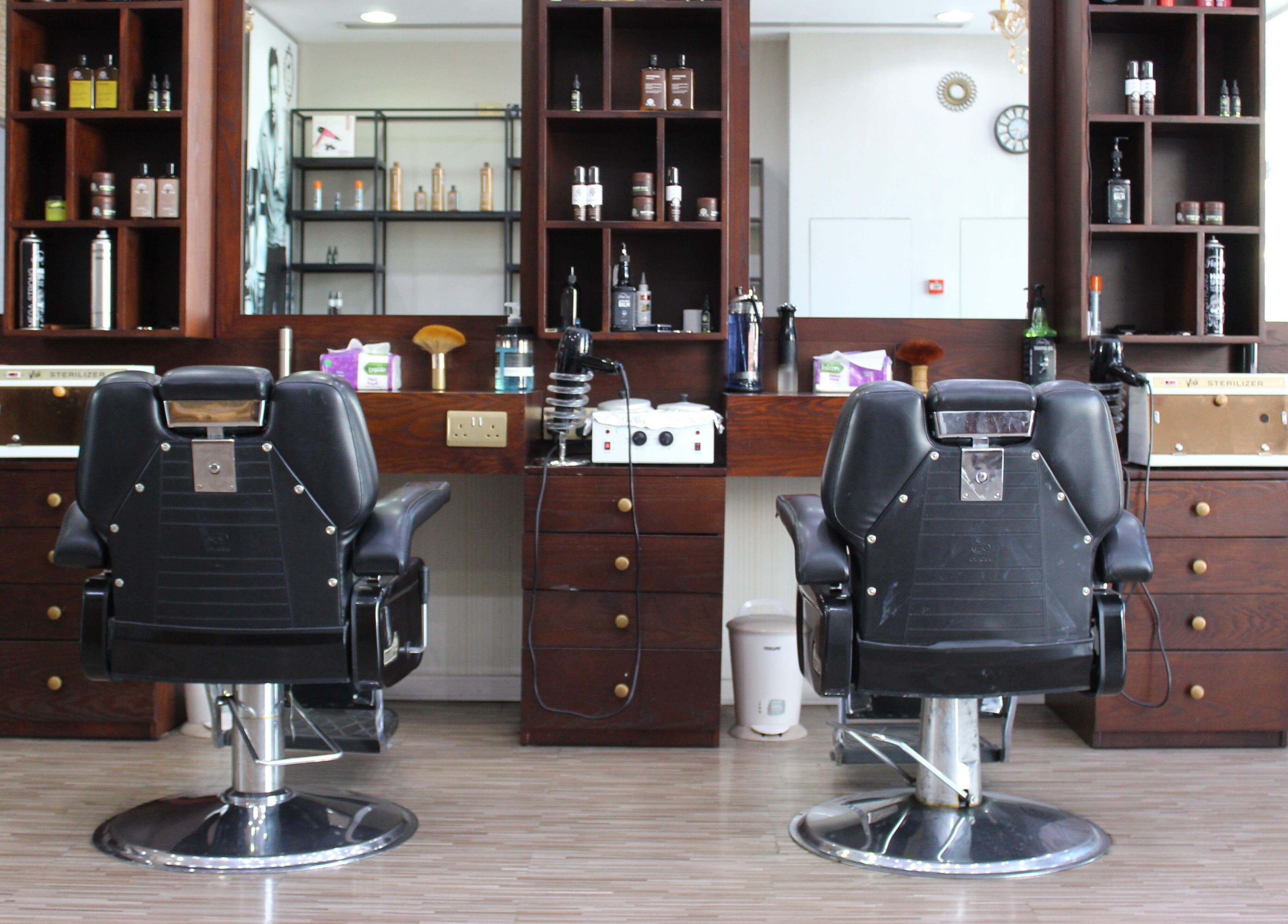Chic barber chairs at The One Gents Salon (Impz Branch), Dubai, Dubai, AE, reflect a stylish grooming space.