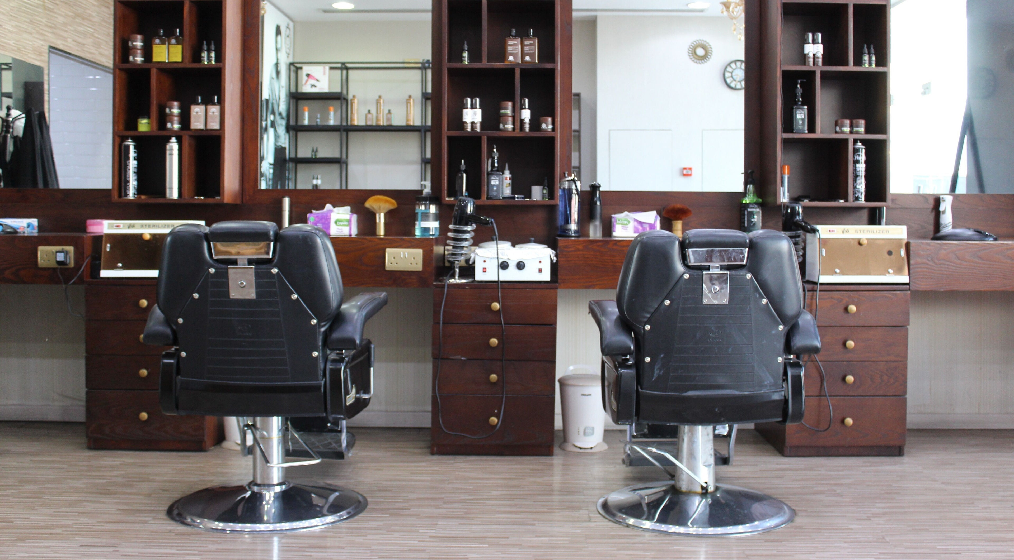 Chic barber chairs at The One Gents Salon (Impz Branch), Dubai, Dubai, AE, reflect a stylish grooming space.