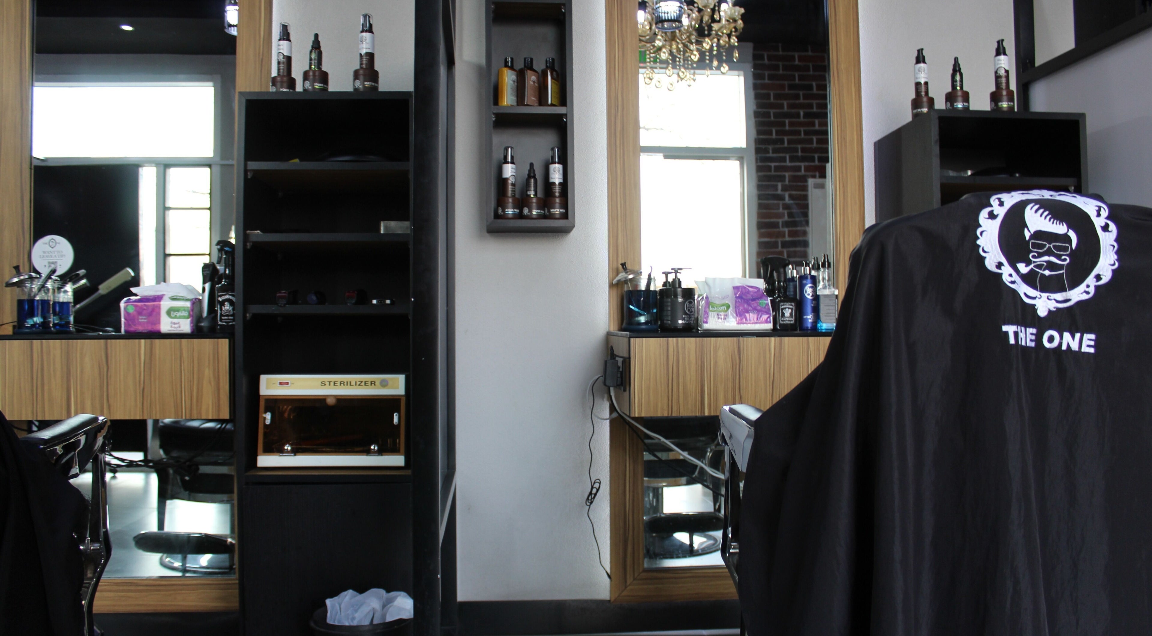 Modern setup at The One Gents Salon (JVT Branch) in Dubai, Dubai, AE with stylish decor and grooming products.