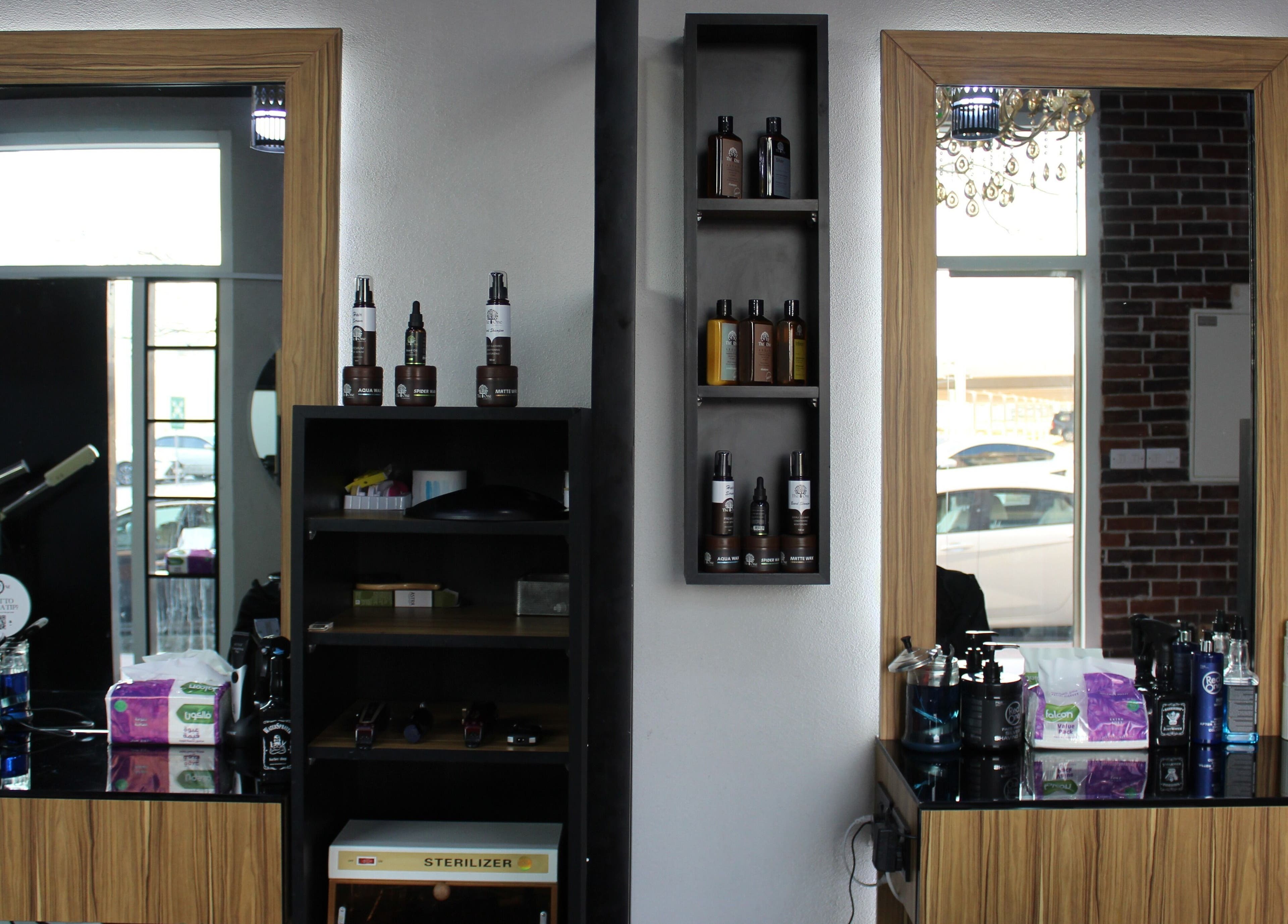 Chic interior of The One Gents Salon (JVT Branch), Dubai, Dubai, AE showcasing grooming products.