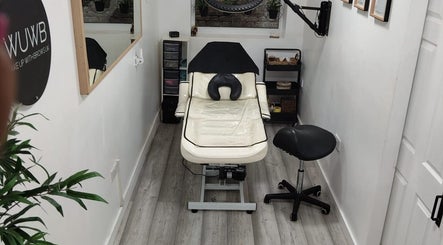 Relaxing treatment room at Wake Up With Brows UK, London, GB, featuring a comfortable chair and modern decor.