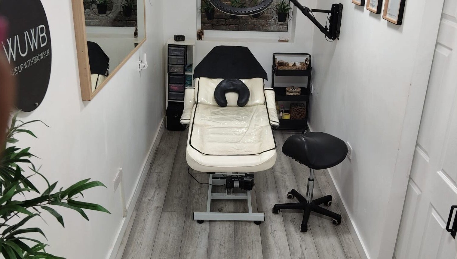 Chic treatment room at Wake Up With Brows UK, London, GB, featuring a comfortable chair and stylish decor.