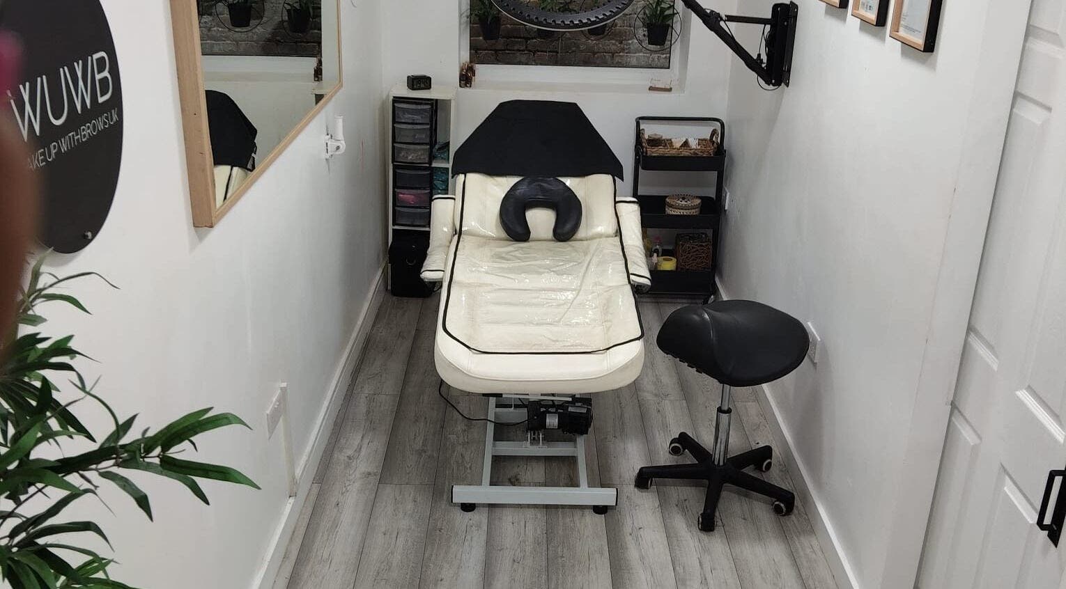 Chic treatment room at Wake Up With Brows UK, London, GB, featuring a comfortable chair and stylish decor.