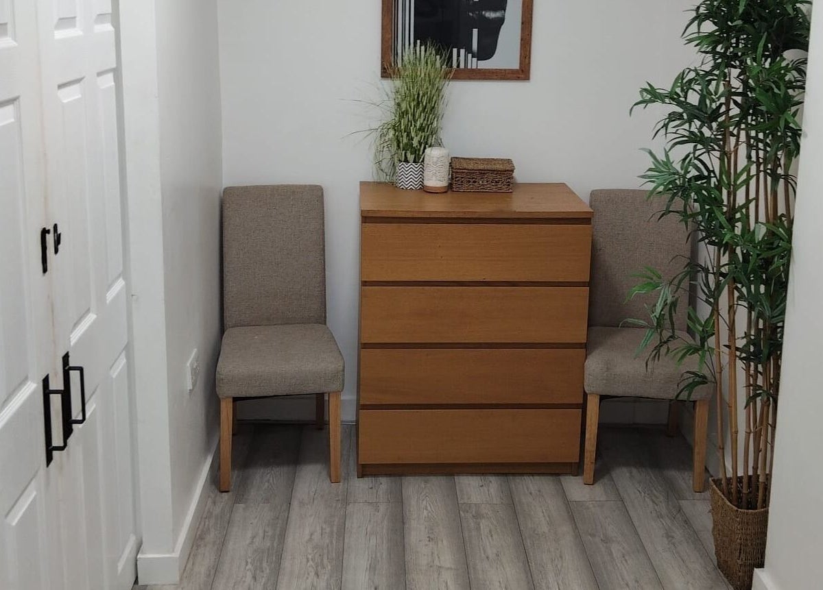 Cozy waiting area at Wake Up With Brows UK, featuring chairs and greenery in London, GB.