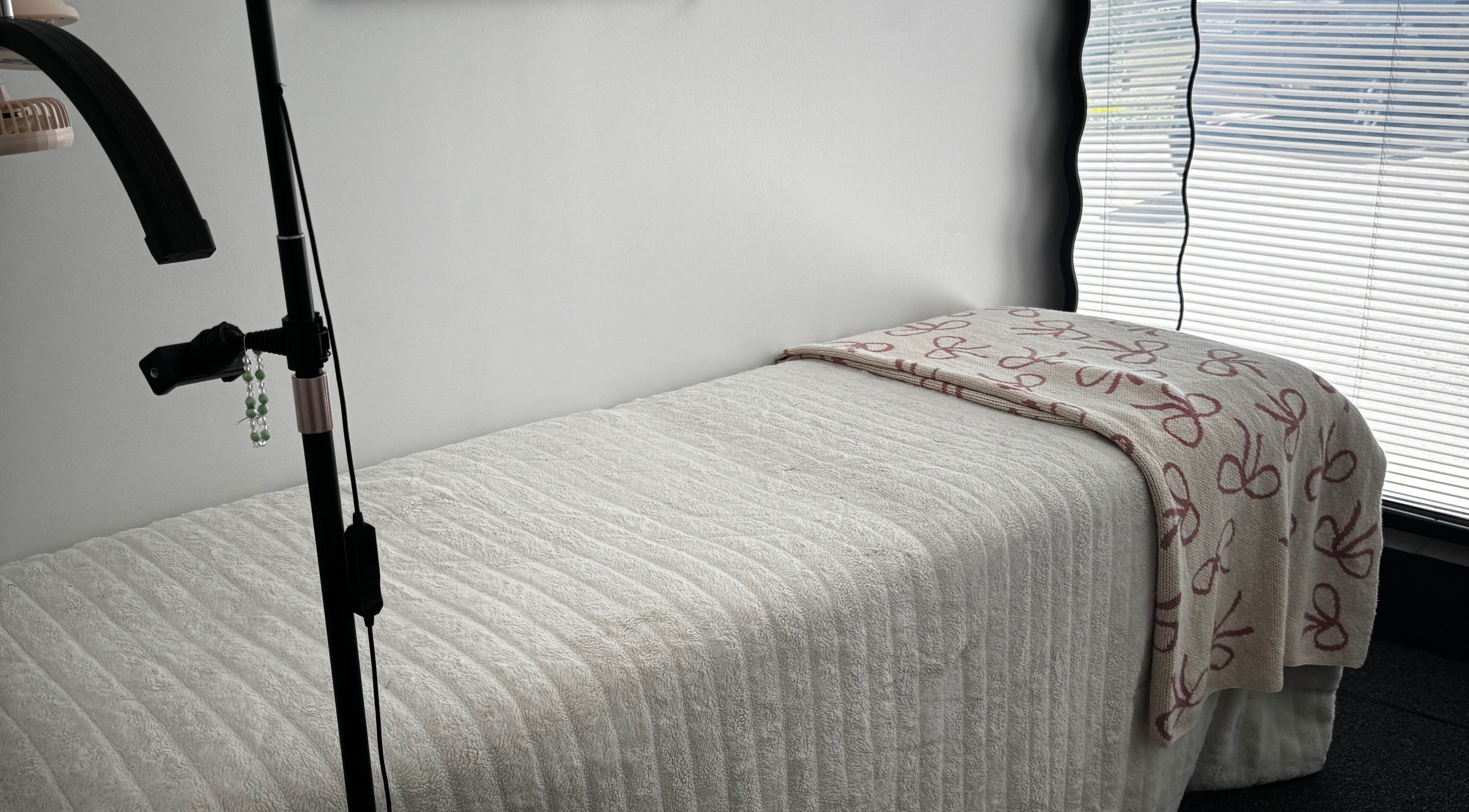 Treatment room at Extensions By JayD in Oakville, Ontario, CA, showcasing a relaxing massage bed.