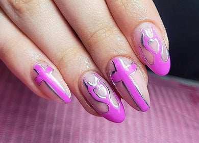 Creative pink nail art at Clouds Beauty Studio, London, England, GB showcasing intricate cross patterns.