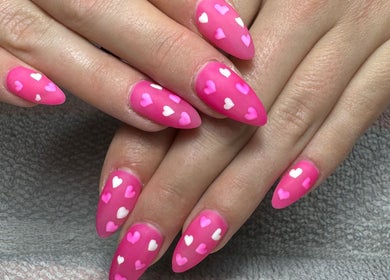 Pink heart-patterned nails at Clouds Beauty Studio, London, England, GB showcase loving nail art designs.