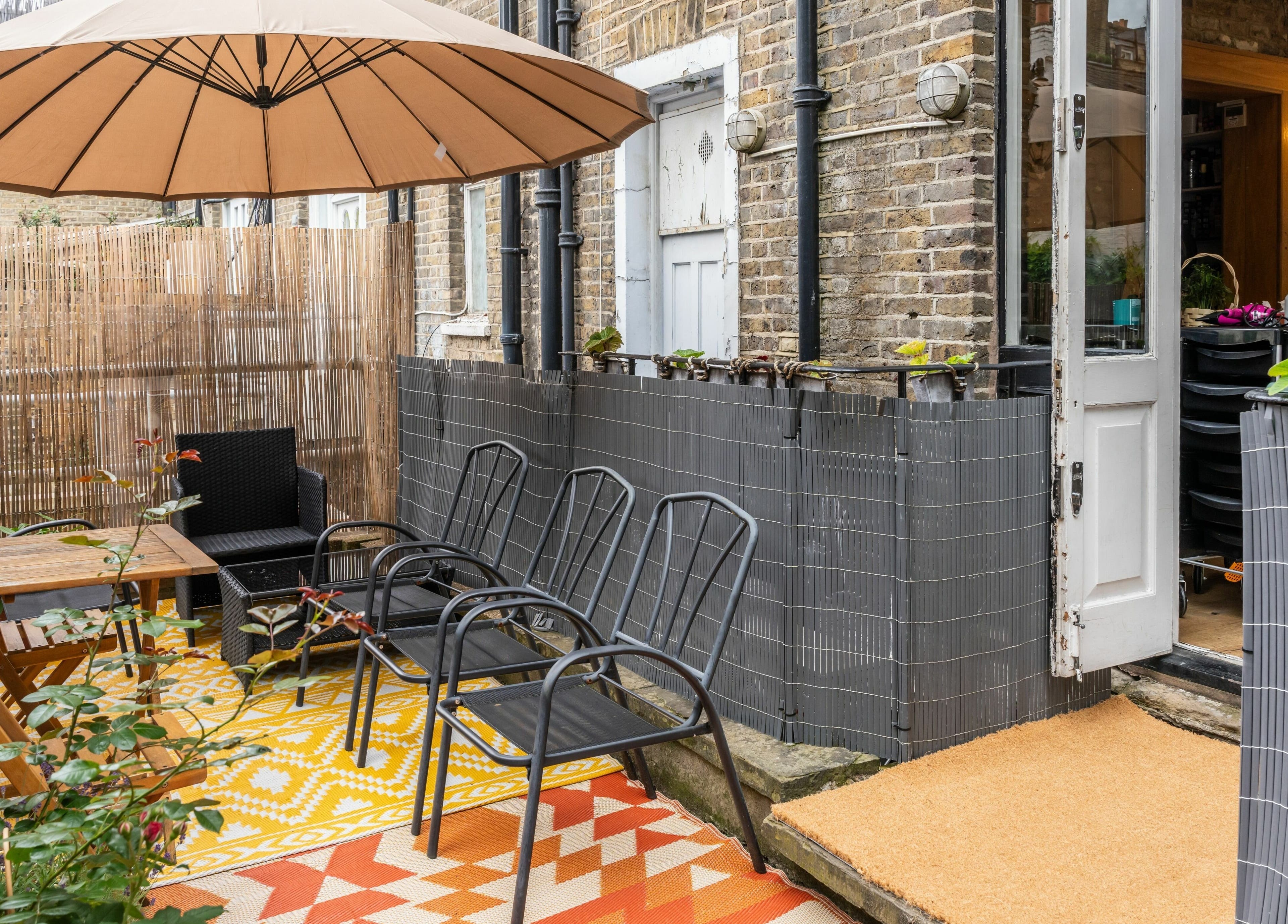 Charming outdoor seating at Chelsea Chair, London, England, GB, with umbrella and chairs for relaxation.