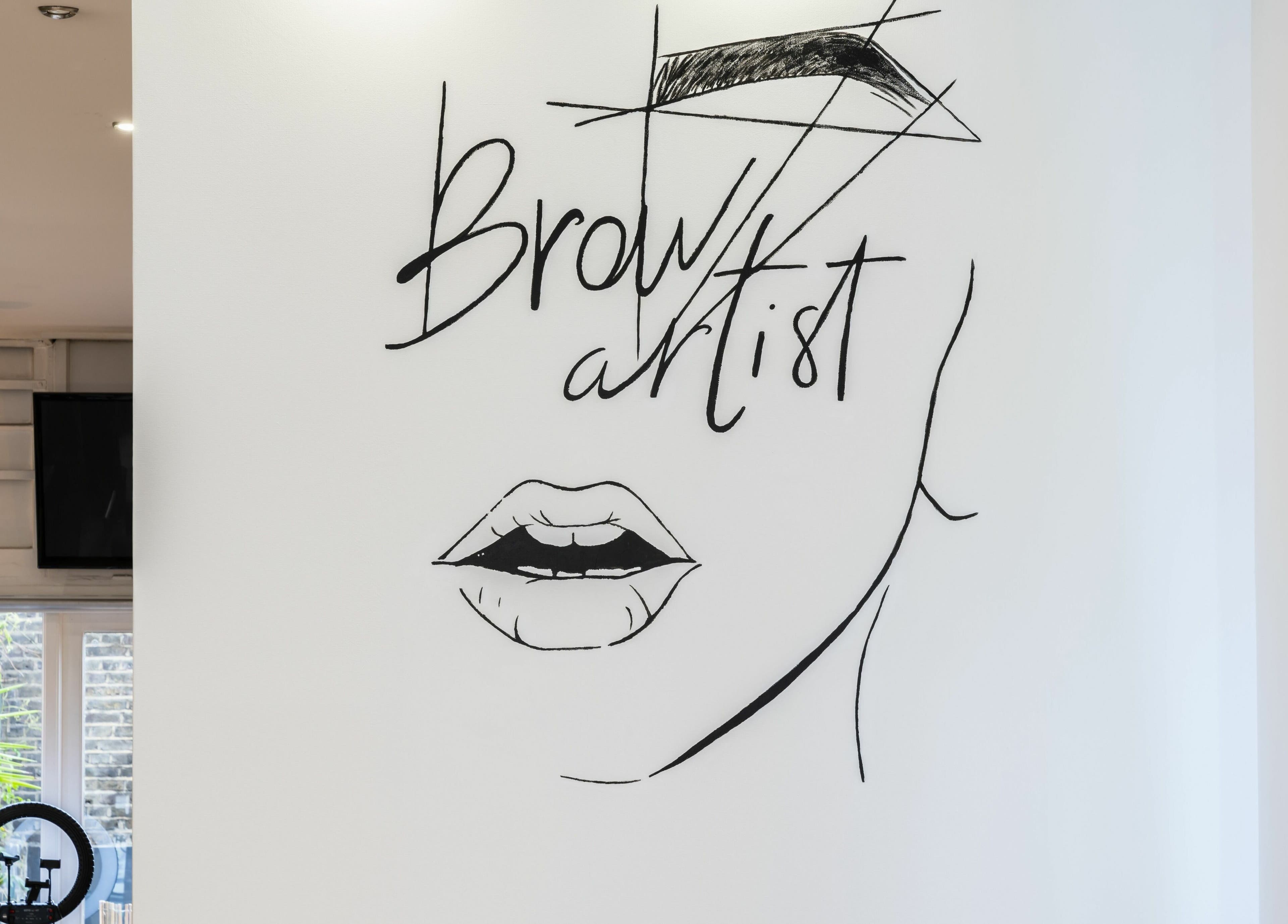 Wall art of brows and lips at Chelsea Chair, a beauty venue in London, England, GB.