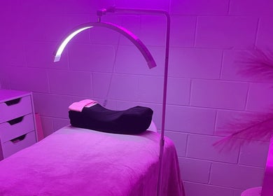 Tranquil treatment room at Luxe Lashes, Maroochydore, Queensland, AU, bathed in soft purple light.