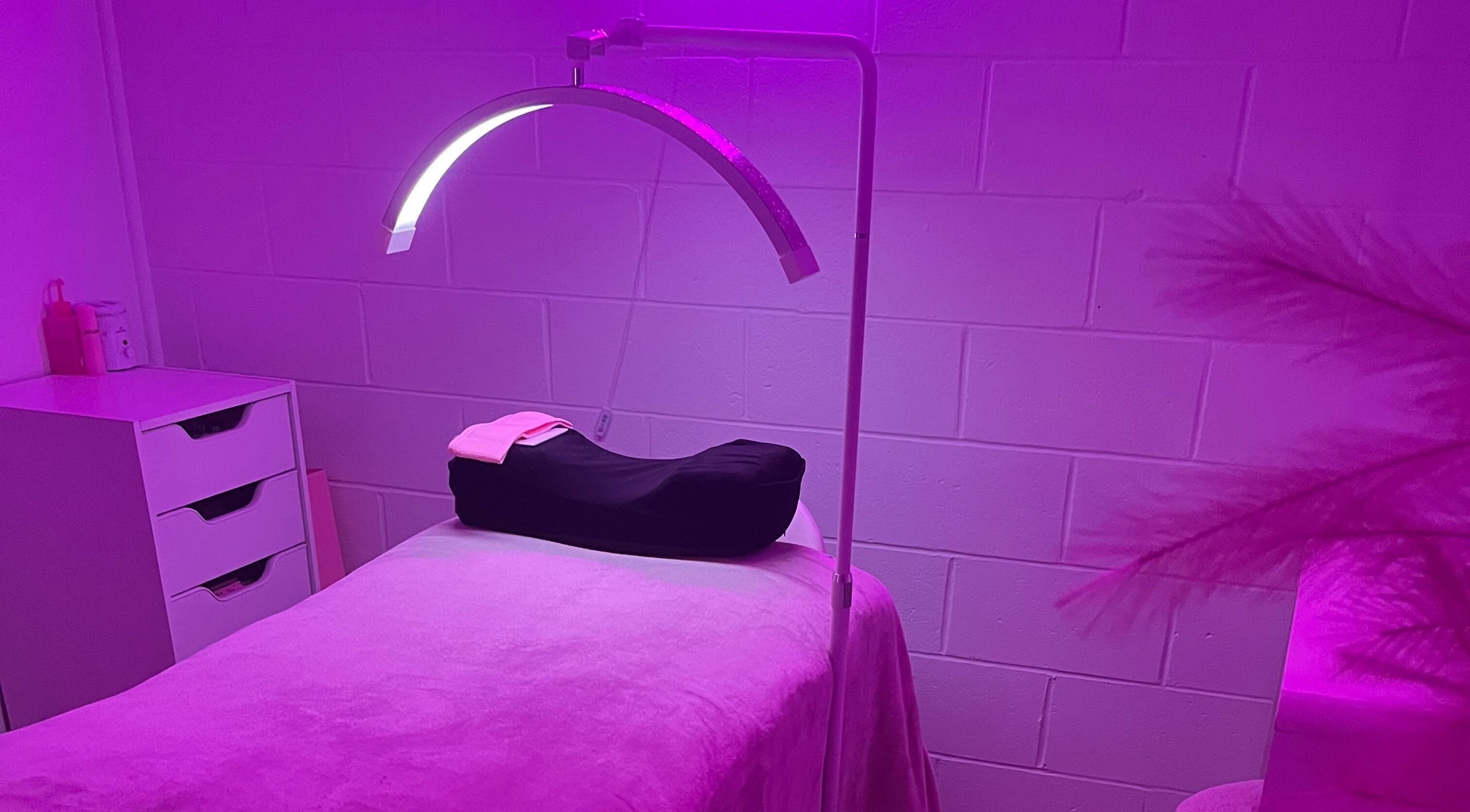 Relaxing spa room at Luxe Lashes, Maroochydore, Queensland, AU, with a calming purple glow.