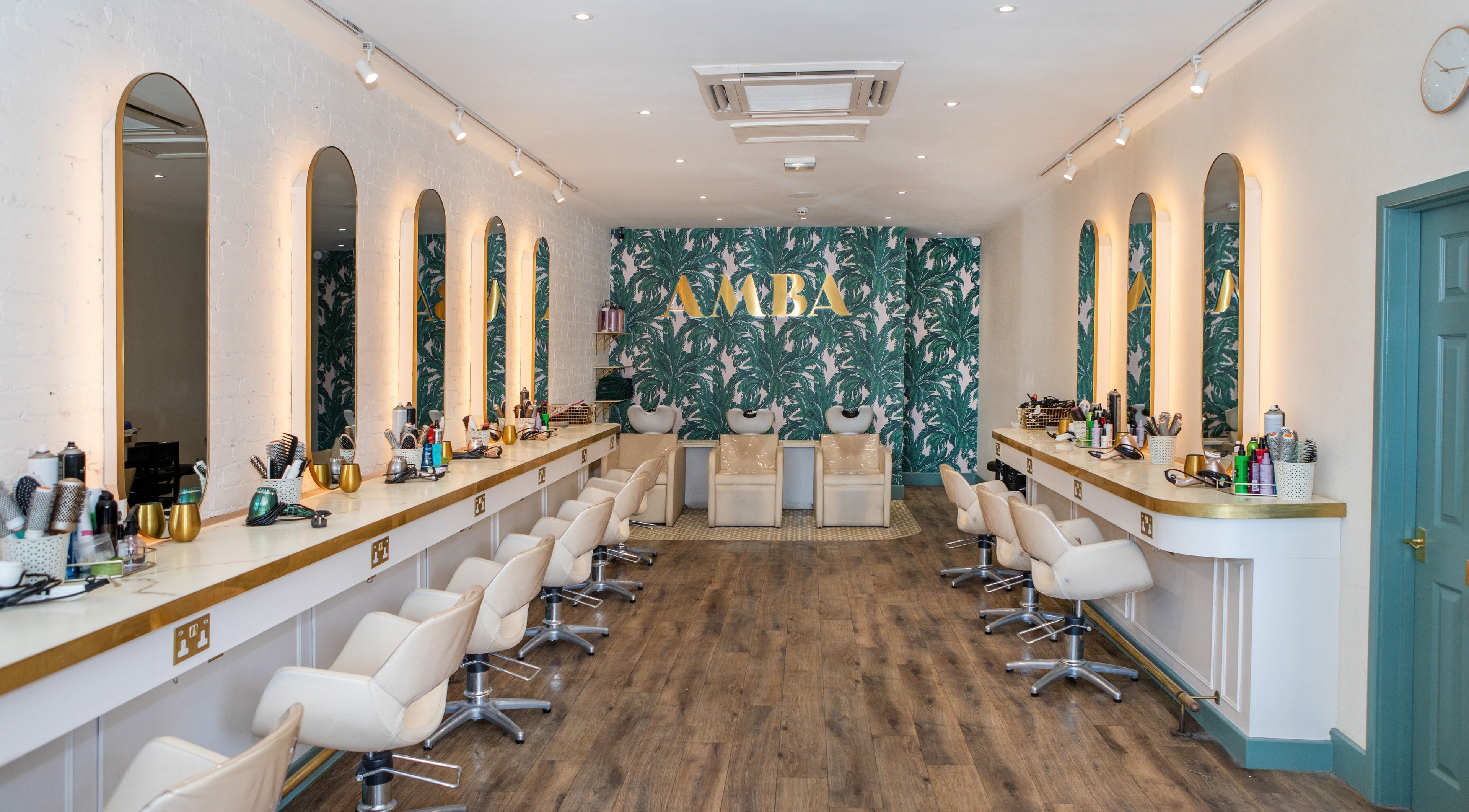 Chic interior of Amba Hair Boutique in London, England, GB featuring stylish salon chairs and lush decor.