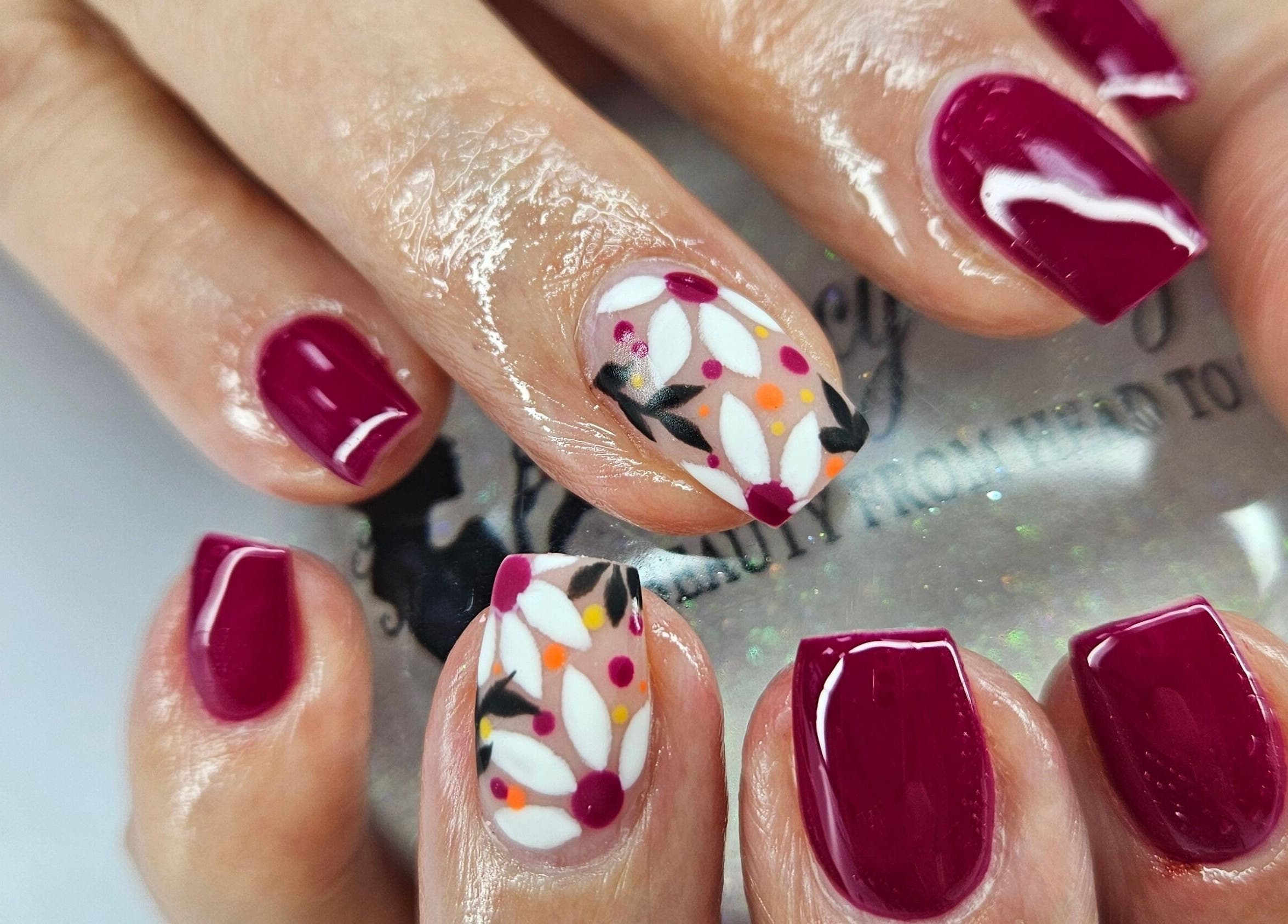 Beautiful floral and burgundy nail art at Fancy Fayce, Huddersfield, England, GB.