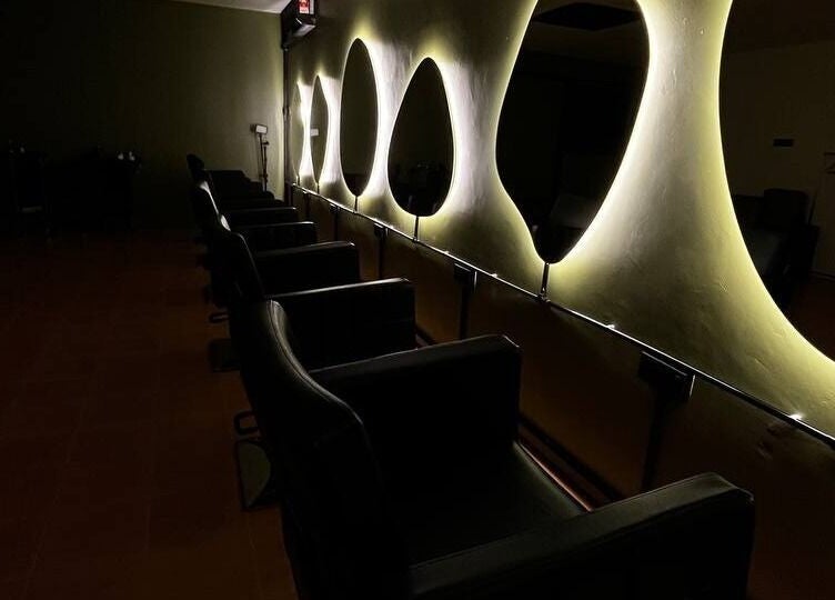 Sleek salon seating with illuminated mirrors at Myfa Salon Indera Makhota 15, Indera Mahkota, Pahang, MY.