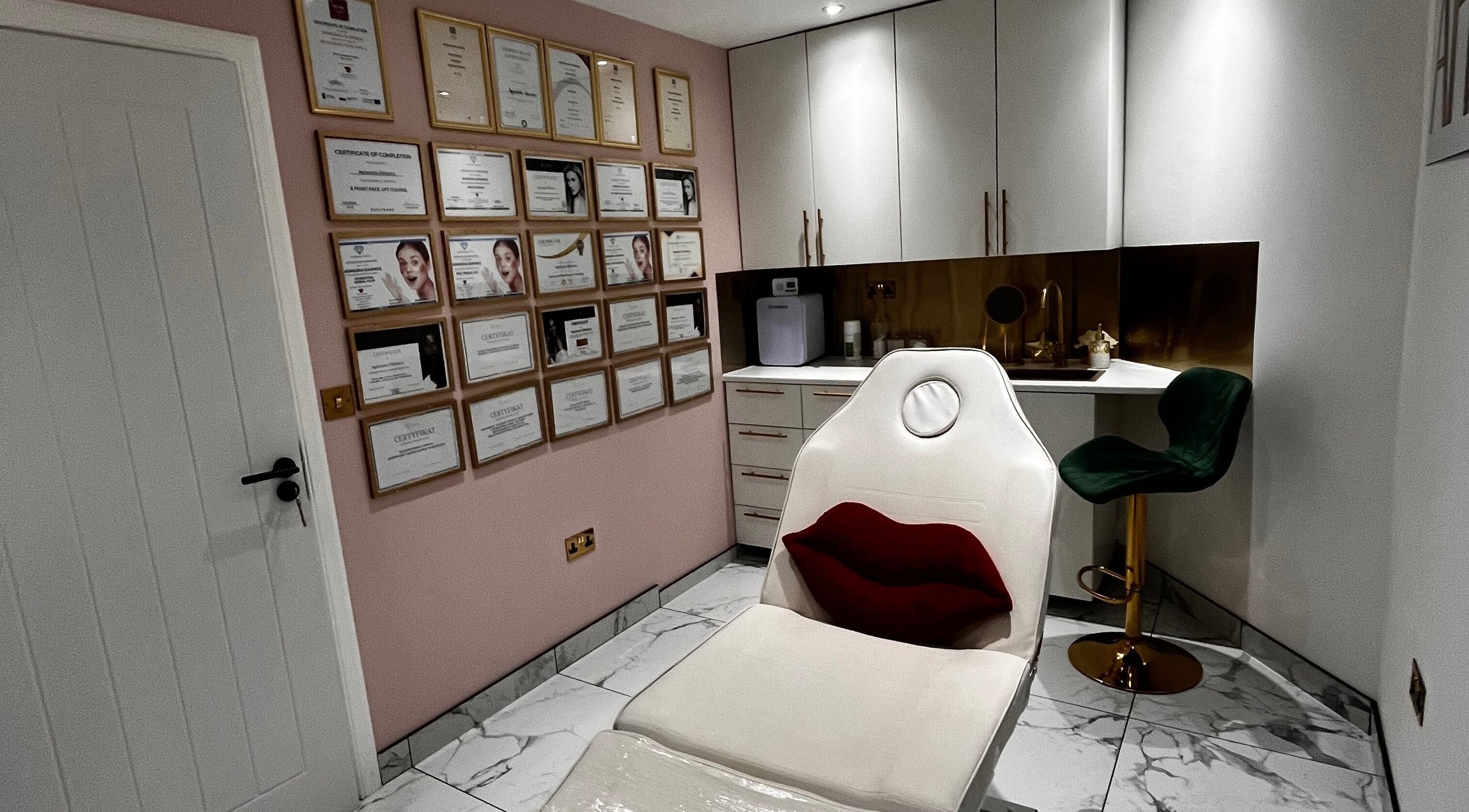 Modern interior of Afrodyta Aesthetic & Beauty Salon in Glasgow, Scotland, with certificates and luxury chair.