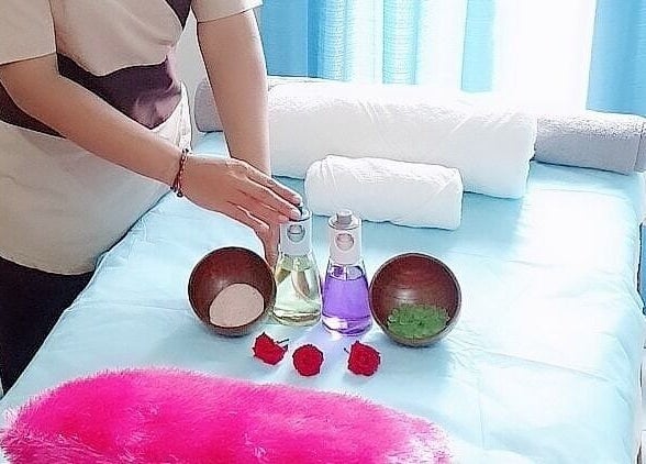 Massage room setup at Anugrah Bali Spa Home, Office and Events, Dubai, AE with oils and towels on a bed.