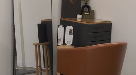 Cozy corner at Unorthodox Salon, Taylors, South Carolina, with a chair and mirror setup.
