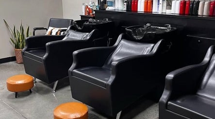 Modern black wash stations at Unorthodox Salon in Taylors, South Carolina, US, highlighting stylish interior.