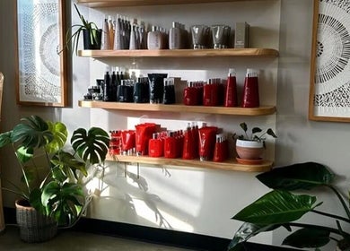 Elegant shelf with beauty products and plants at Unorthodox Salon, Taylors, South Carolina, US.